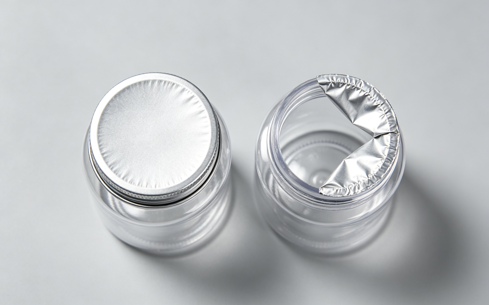 Macro overhead view of two PET bottle tops side by side: a perfect wrinkle-free aluminum foil induction seal on the left and a wrinkled partially adhered defective foil seal on the right