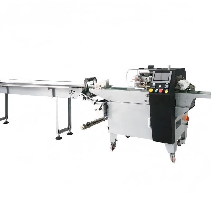 Flow wrapper film feed and sealing section in a food packaging plant